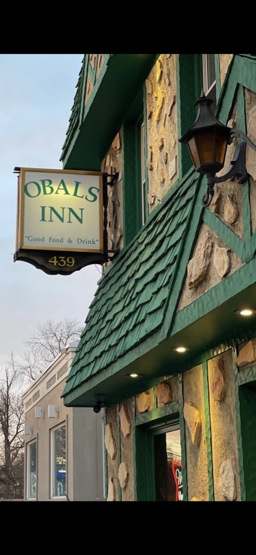 The green shingled storefront of Obal's Inn on Broad Street, with its hand painted Good Food and Drink sign and lantern